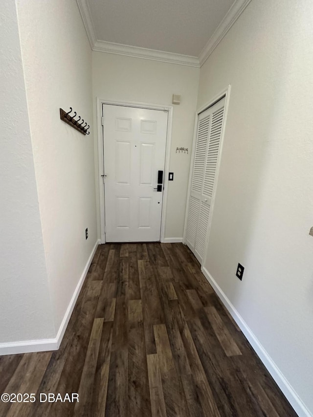 corridor featuring dark wood-type flooring and ornamental molding