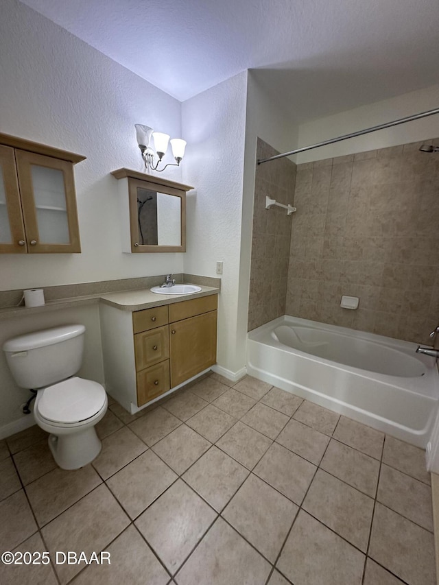 full bathroom with vanity, tiled shower / bath combo, tile patterned floors, and toilet