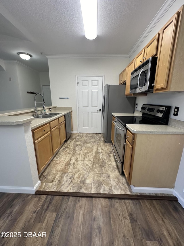 kitchen with sink, light hardwood / wood-style flooring, a textured ceiling, ornamental molding, and stainless steel appliances