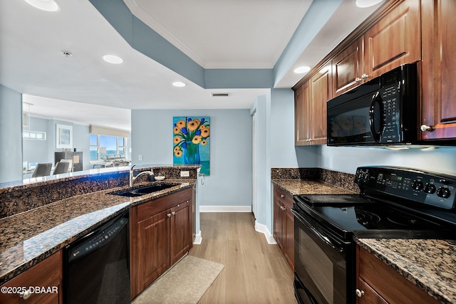 3315 S Atlantic Ave Unit 1605, Daytona Beach Shores, FL 32118 - kitchen featuring black appliances, a sink, light wood-style floors, dark stone counters, and recessed lighting
