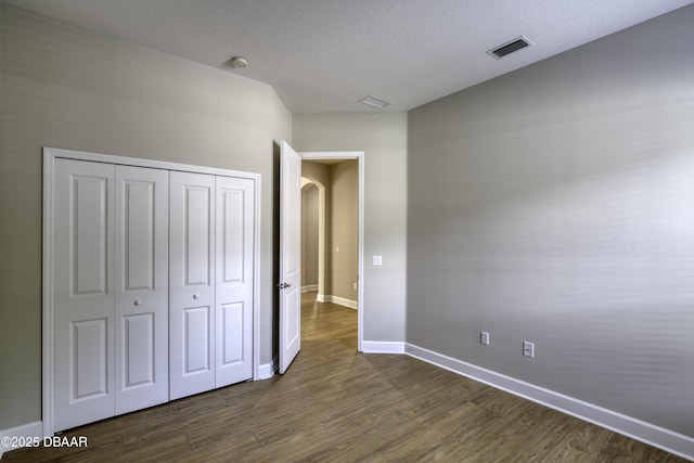 408 Chelsea Place Ave, Ormond Beach, FL 32174 - unfurnished bedroom with arched walkways, baseboards, visible vents, and dark wood-type flooring