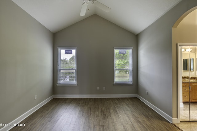 408 Chelsea Place Ave, Ormond Beach, FL 32174 - empty room featuring arched walkways, ceiling fan, wood finished floors, and a healthy amount of sunlight