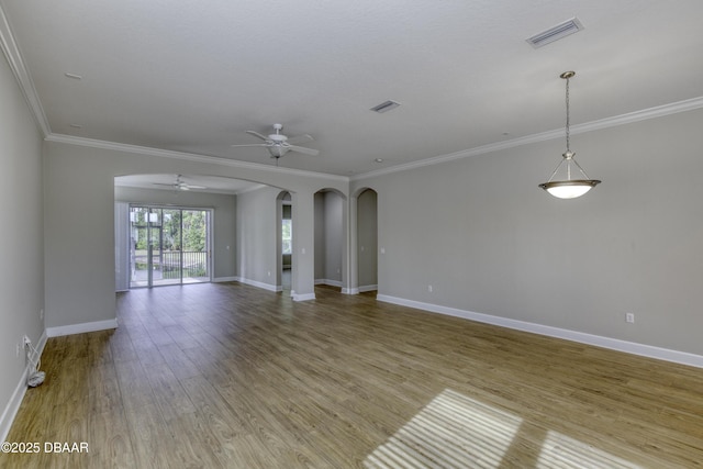 408 Chelsea Place Ave, Ormond Beach, FL 32174 - unfurnished living room featuring ceiling fan, arched walkways, baseboards, visible vents, and ornamental molding