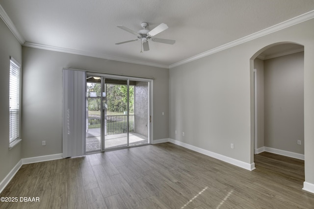 408 Chelsea Place Ave, Ormond Beach, FL 32174 - empty room featuring baseboards, arched walkways, ceiling fan, and wood finished floors