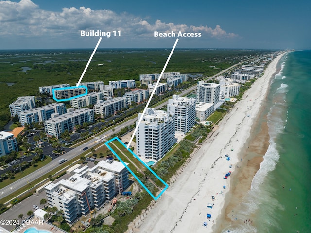 birds eye view of property with a beach view and a water view