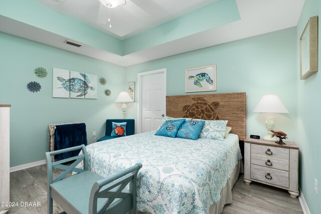 bedroom with ceiling fan and light wood-type flooring