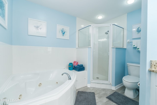 full bathroom featuring shower with separate bathtub, toilet, and vanity