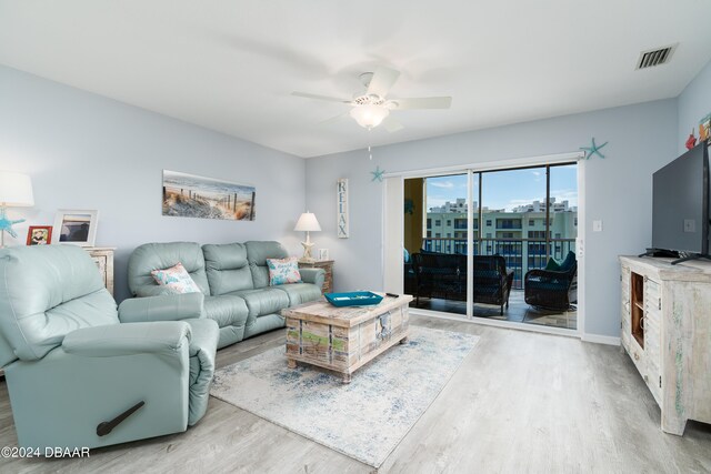 living room featuring ceiling fan and light wood-type flooring