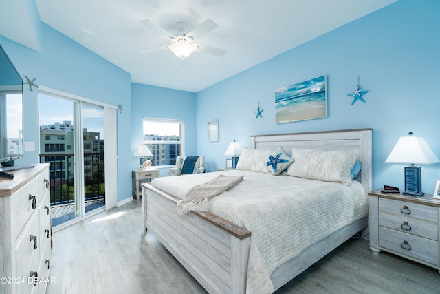 bedroom featuring light hardwood / wood-style floors, ceiling fan, and access to outside