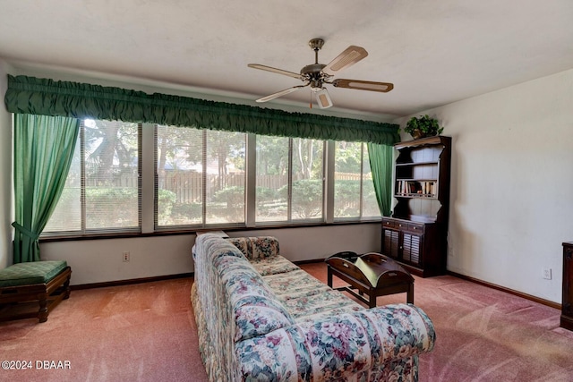 carpeted living room with ceiling fan