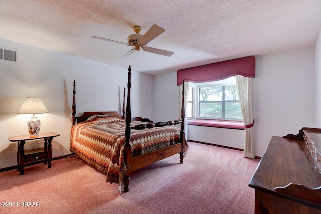 carpeted bedroom featuring a textured ceiling and ceiling fan