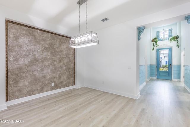 unfurnished dining area with light wood-type flooring