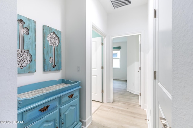 hallway with light hardwood / wood-style flooring