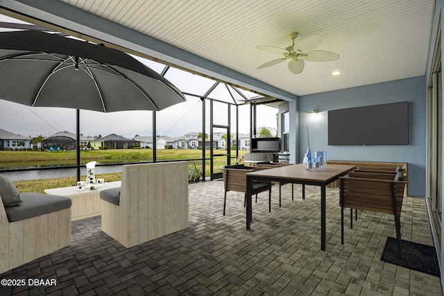 view of patio / terrace with a lanai, ceiling fan, and a water view