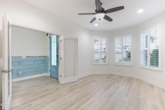 unfurnished room with light hardwood / wood-style floors and ceiling fan