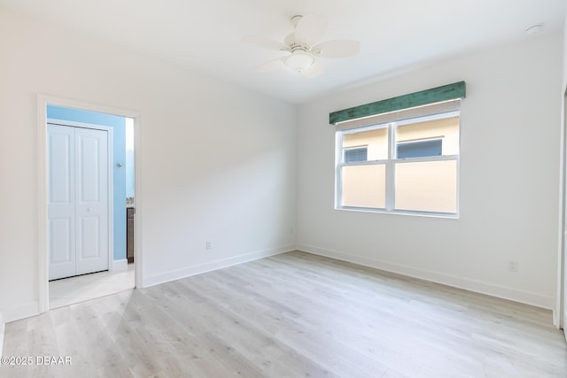 spare room featuring ceiling fan and light hardwood / wood-style floors