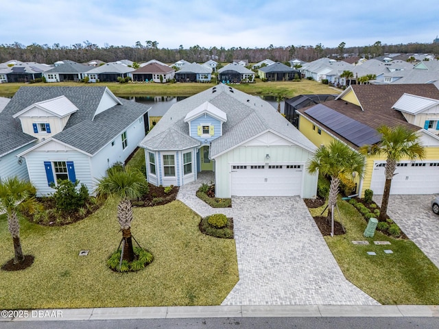 view of front of property with a garage and a front yard