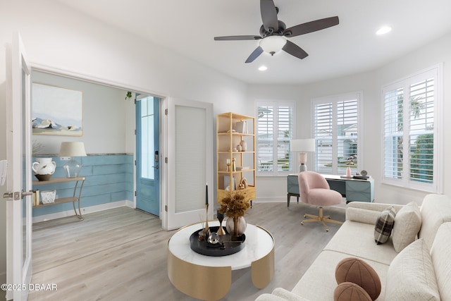 living room featuring ceiling fan and light wood-type flooring