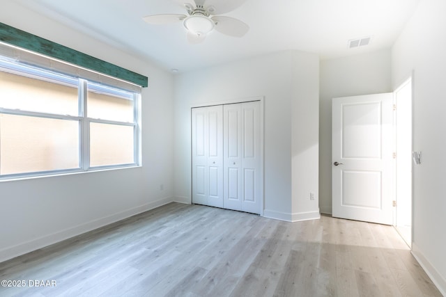 unfurnished bedroom with a closet, ceiling fan, and light wood-type flooring