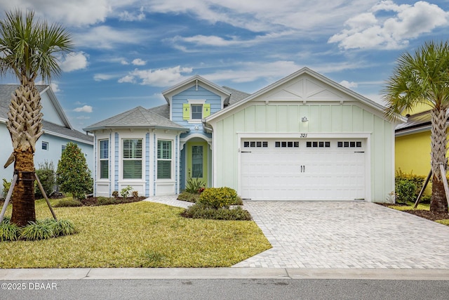 view of front of house with a garage and a front yard