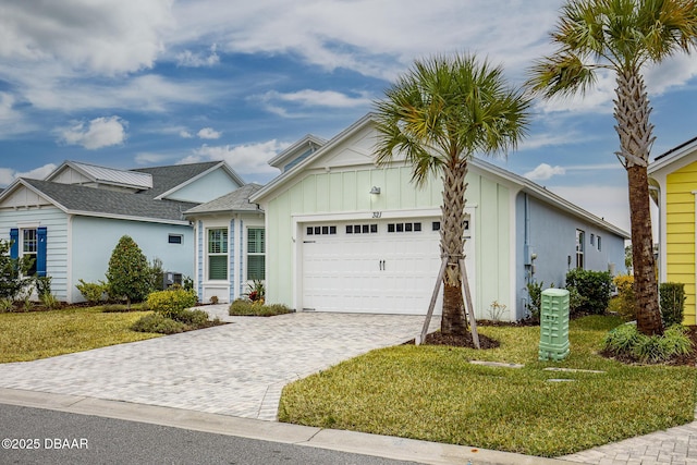 ranch-style house with central AC, a garage, and a front yard