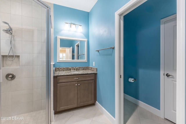 bathroom featuring vanity, a shower with shower door, and tile patterned flooring