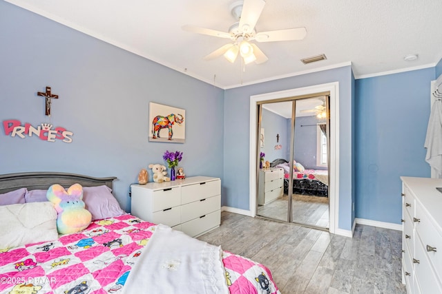 3618 Dame St, Port Orange, FL 32129 - bedroom featuring light wood finished floors, a closet, ceiling fan, and ornamental molding