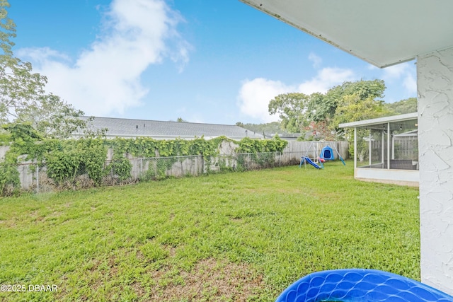 3618 Dame St, Port Orange, FL 32129 - fenced backyard with a sunroom and a playground