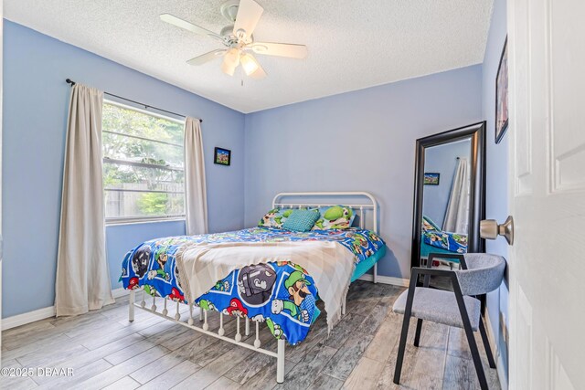3618 Dame St, Port Orange, FL 32129 - bedroom featuring a textured ceiling, wood finished floors, and a ceiling fan