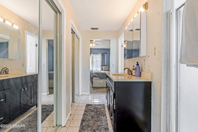 3618 Dame St, Port Orange, FL 32129 - full bath featuring ensuite bath, two vanities, a ceiling fan, a textured ceiling, and tile patterned floors