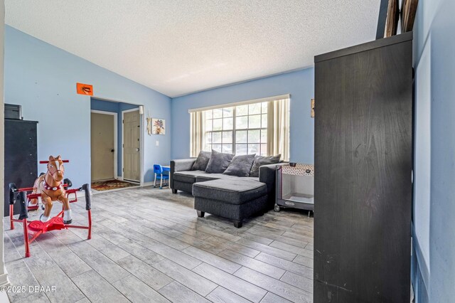 3618 Dame St, Port Orange, FL 32129 - living room featuring light wood-type flooring and a textured ceiling