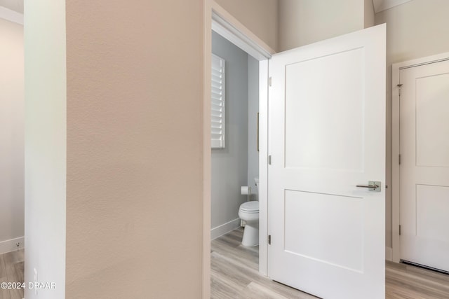 bathroom featuring hardwood / wood-style flooring and toilet