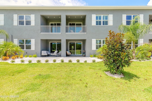 back of house featuring a yard and a patio