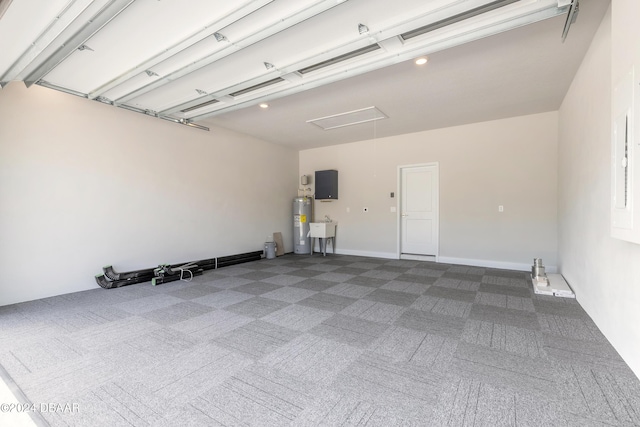 garage with electric water heater, electric panel, and sink