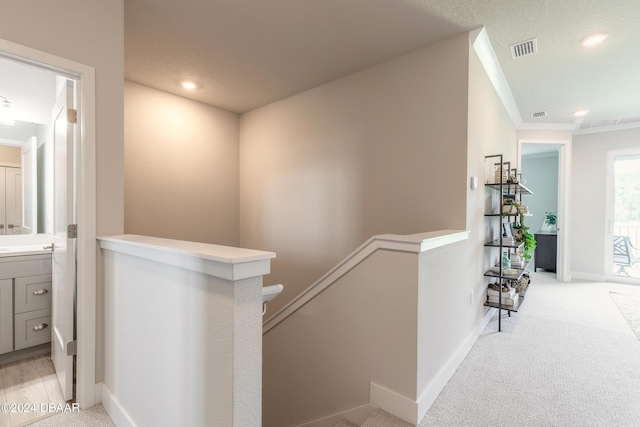 3066 Isles Way, New Smyrna Beach, FL 32168 - hall with an upstairs landing, light colored carpet, recessed lighting, and crown molding