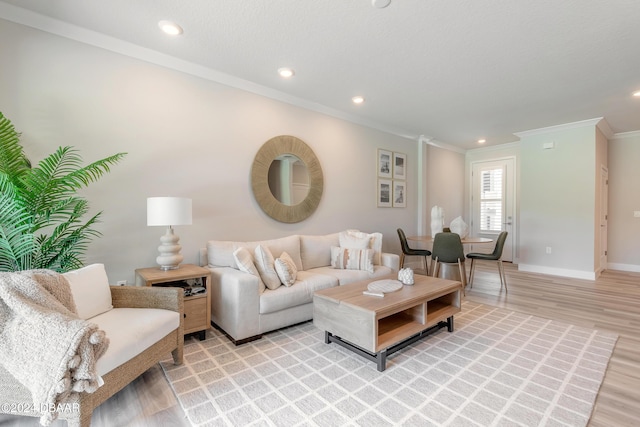 3066 Isles Way, New Smyrna Beach, FL 32168 - living area with crown molding, light wood finished floors, and recessed lighting