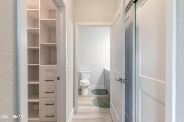 bathroom featuring hardwood / wood-style flooring, vanity, and toilet