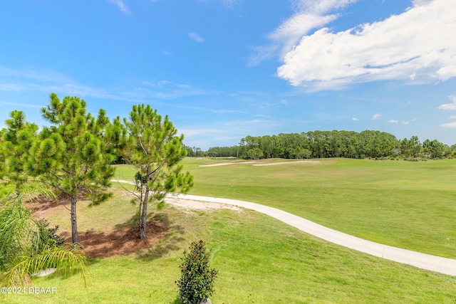 3066 Isles Way, New Smyrna Beach, FL 32168 - view of community with golf course view, a lawn, and view of wooded area