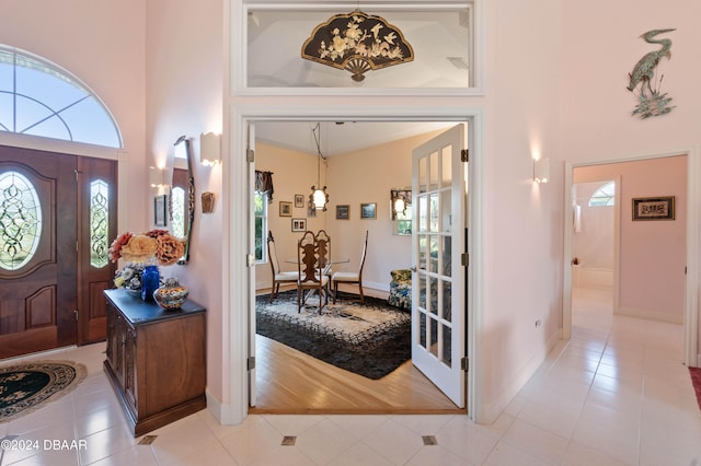 entryway featuring a high ceiling and light wood-type flooring