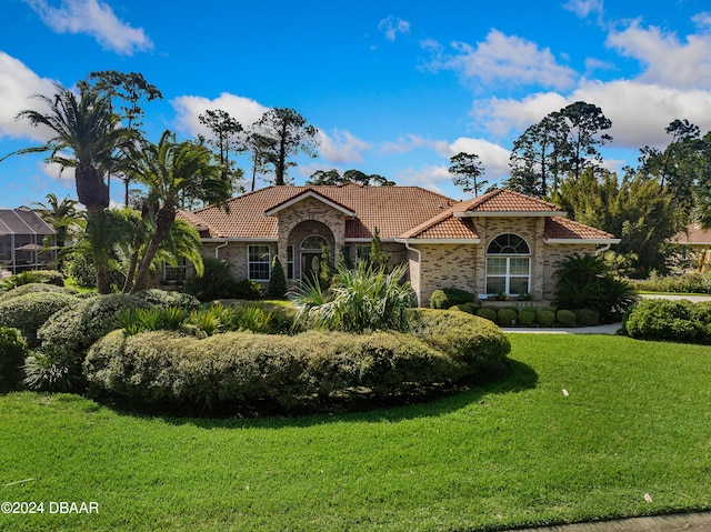 mediterranean / spanish-style house with a front yard