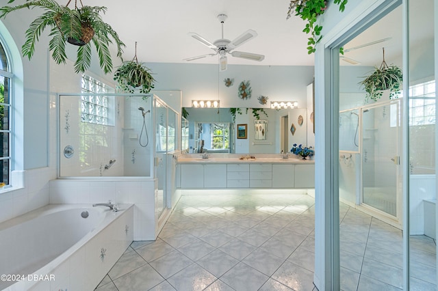 bathroom with tile patterned flooring, a healthy amount of sunlight, and plus walk in shower