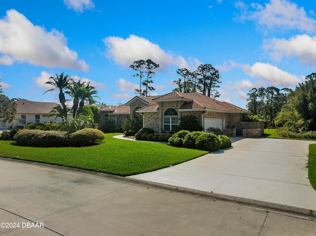 view of front of property with a garage and a front lawn