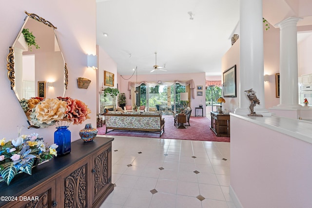 bedroom with ornate columns, high vaulted ceiling, and light tile patterned floors