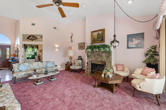 carpeted living room featuring high vaulted ceiling, a high end fireplace, and ceiling fan