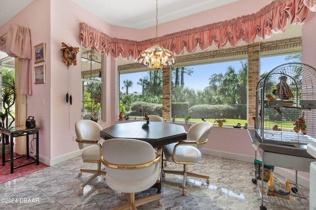 dining space with an inviting chandelier