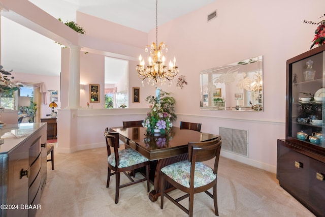 carpeted dining space with an inviting chandelier and ornate columns