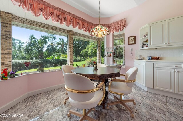 dining room with a healthy amount of sunlight and an inviting chandelier