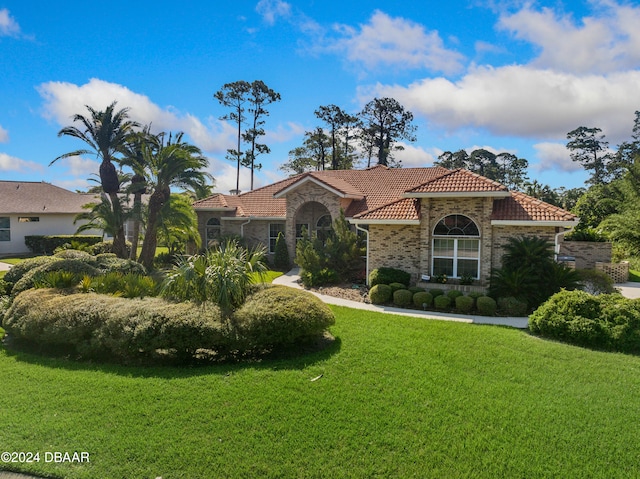 mediterranean / spanish-style house with a front lawn