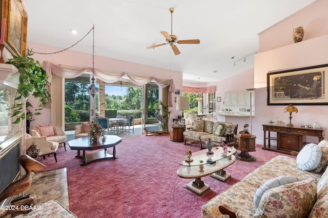 carpeted living room with high vaulted ceiling and ceiling fan