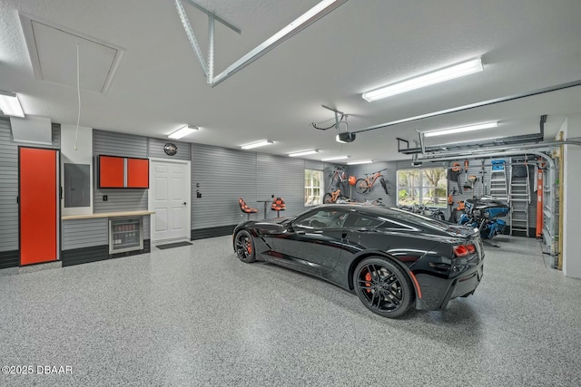 garage with electric panel and a garage door opener